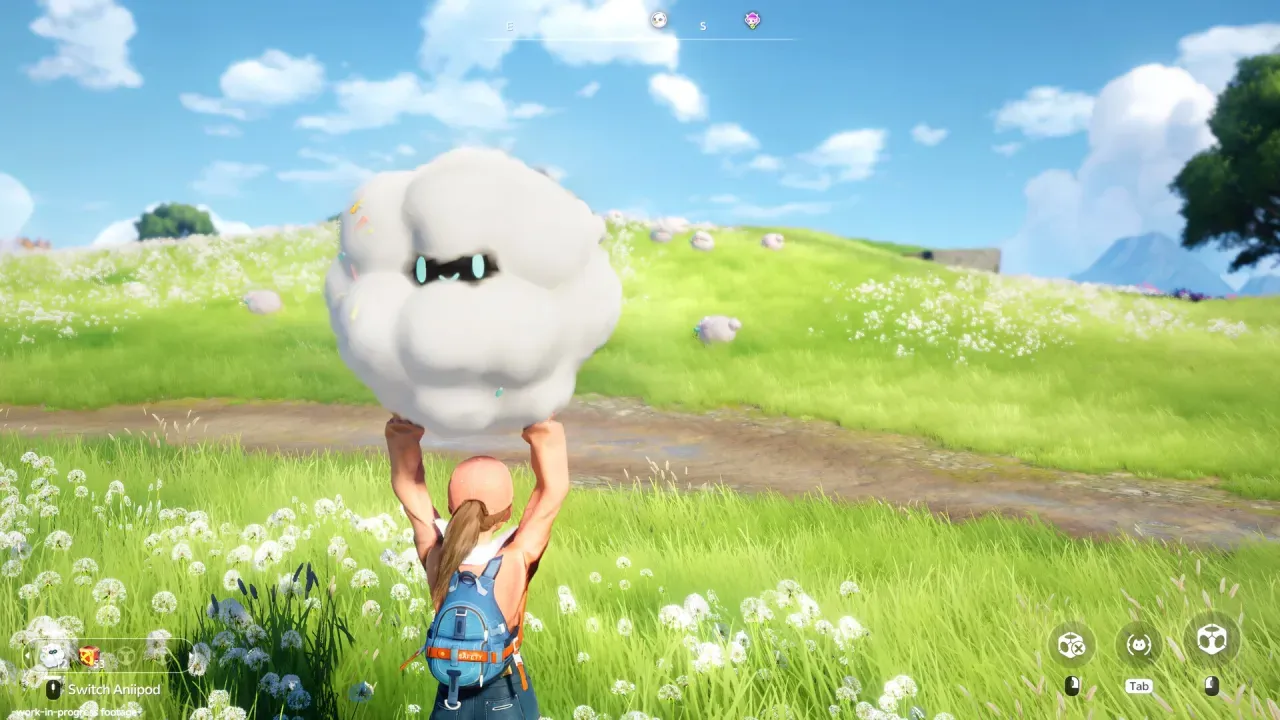 A player in a blue backpack lifts a round white cloud-like Aniimo overhead in a flower meadow